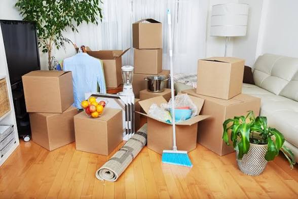 Moving boxes and cleaning supplies in a living room